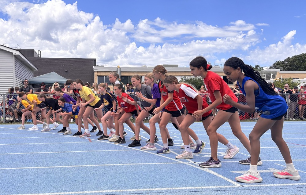 Track athletes line up at starting line before race