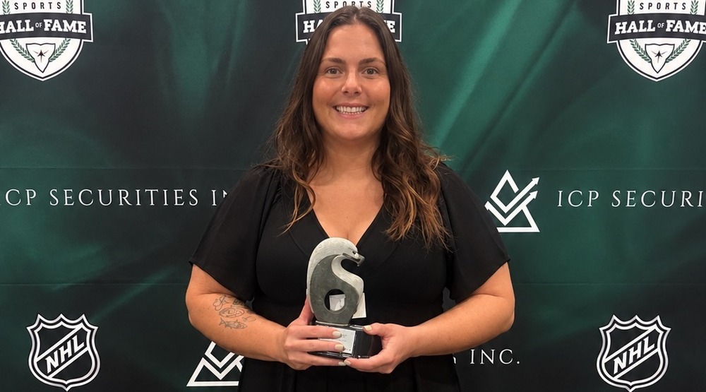 Samantha Meredith posing with Inductee medal