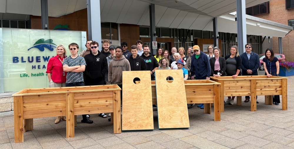GLSS students pose with BlueWater Health staff and patients to present woodworking goods
