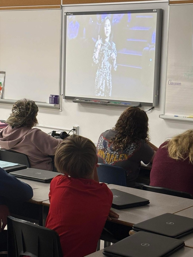 grade 7 and 8 students sitting and watching a Ted Talk from their desks 