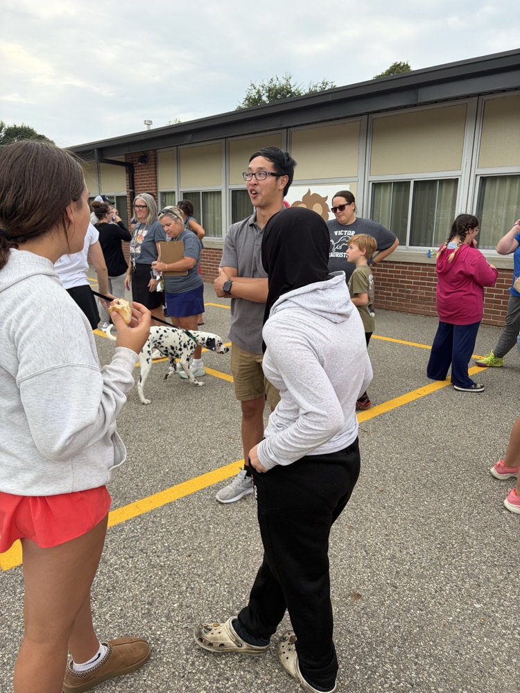 teacher is talking with families out on the playground