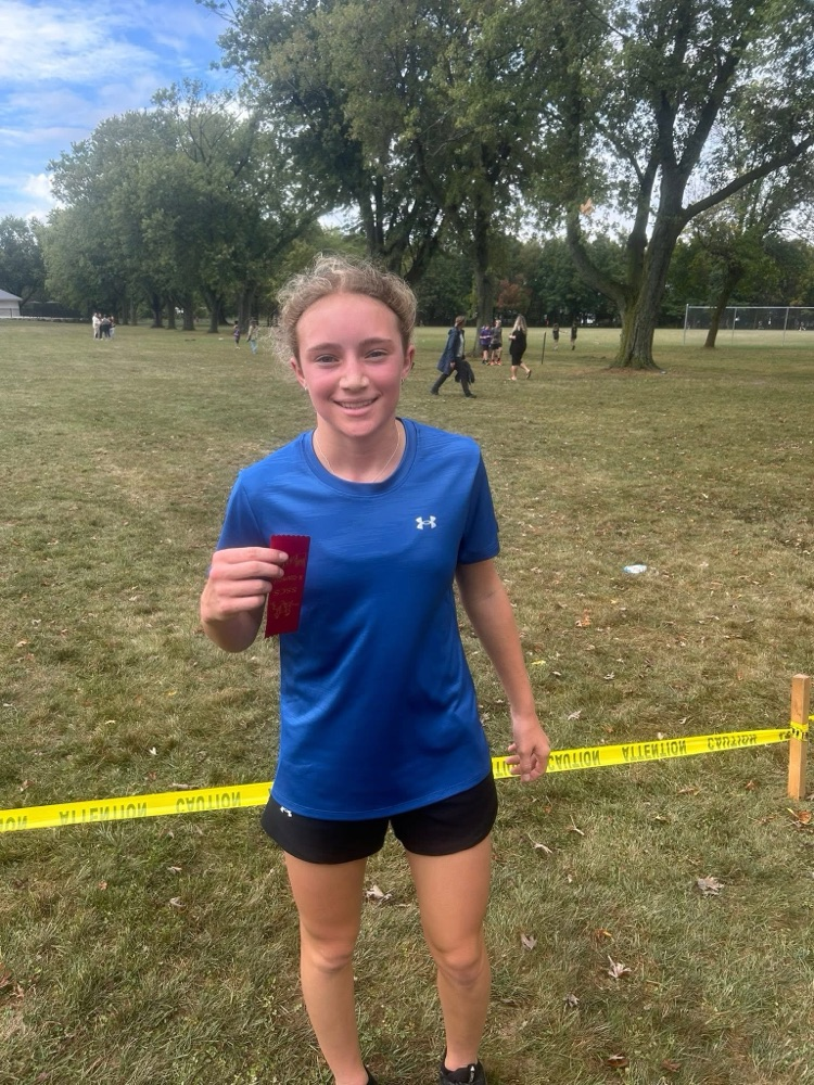 grade 8 girl standing after her running race with a 1st place ribbon
