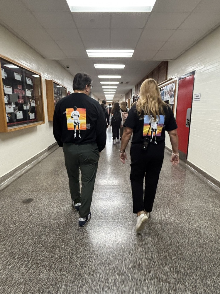 Gary and Melissa walking down hall