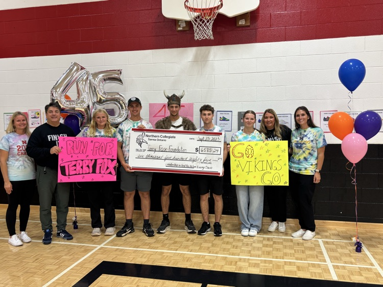 Gary posing with students and cheque  