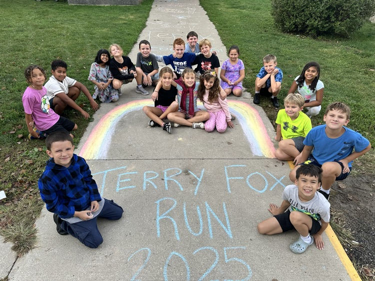 Class sitting in front of sidewalk chalk drawing for Terry Fox run