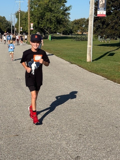 Grade 6 boy running for Terry Fox and smiling at the camera