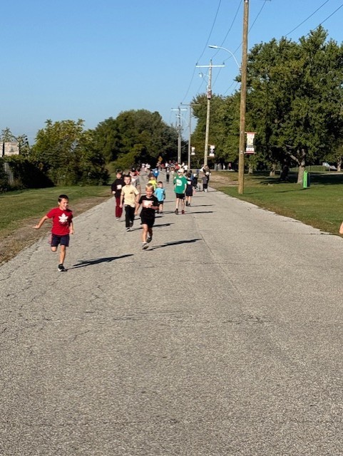 2 young students running outside on a road for Terry Fox 2025
