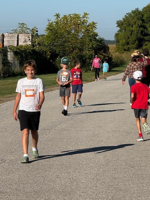 students walking and running outside on a road for Terry Fox 2025