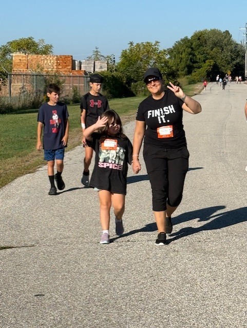 Ms. Cottingham walking with a student for Terry Fox, 2 boys walking behind them