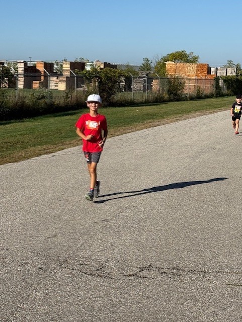young male student running outside on a road for Terry Fox 2025