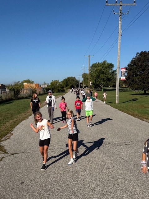 two girls dancing their way to the camera during the Terry Fox Run outside today