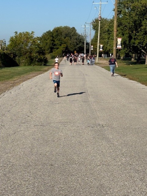 young male student running outside on a road for Terry Fox 2025