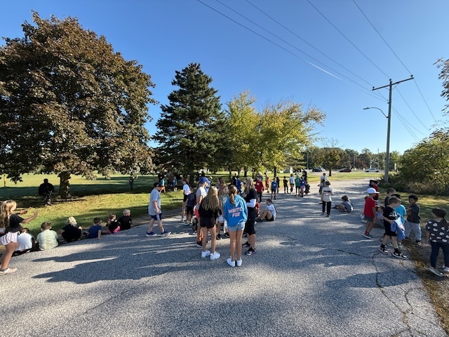 a large group of tired students sitting and standing at the end of the Terry Fox Run today
