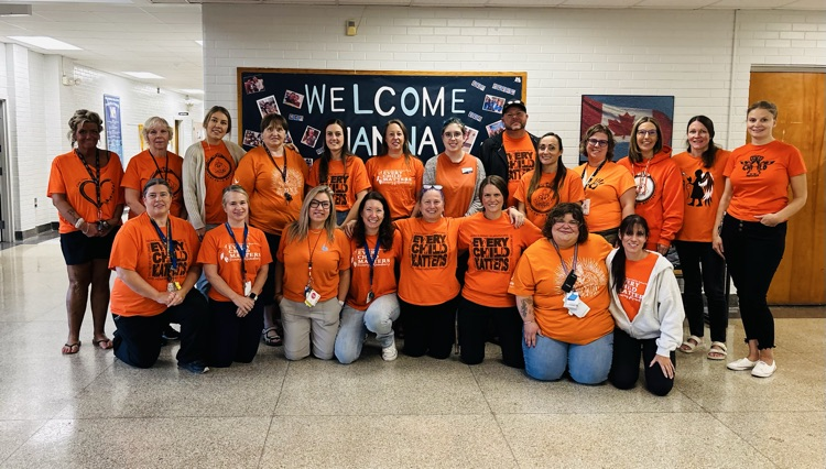 staff wearing orange shirts