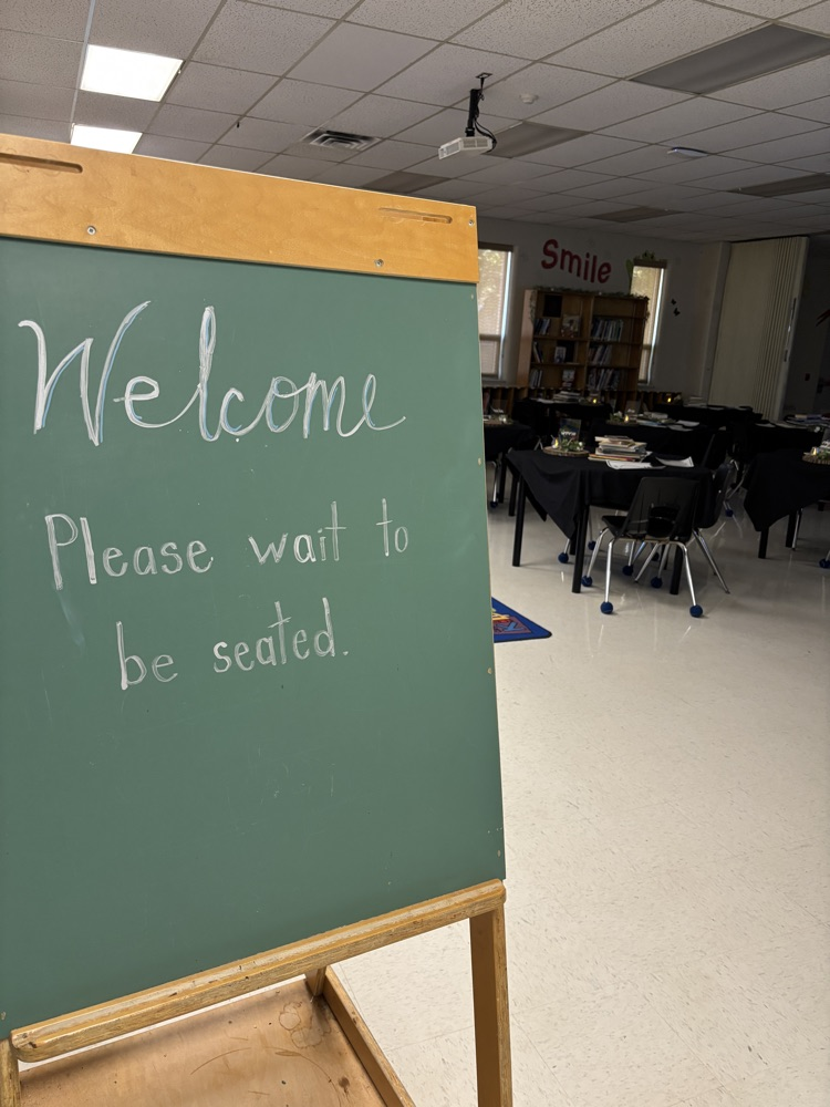 A welcome please be seated sign