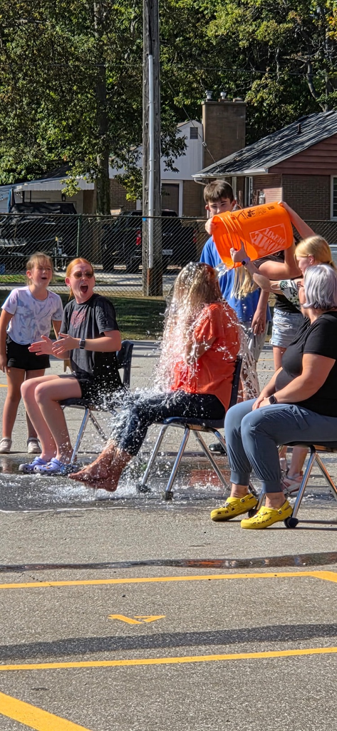 bucket of water being dumped on a teacher by students 