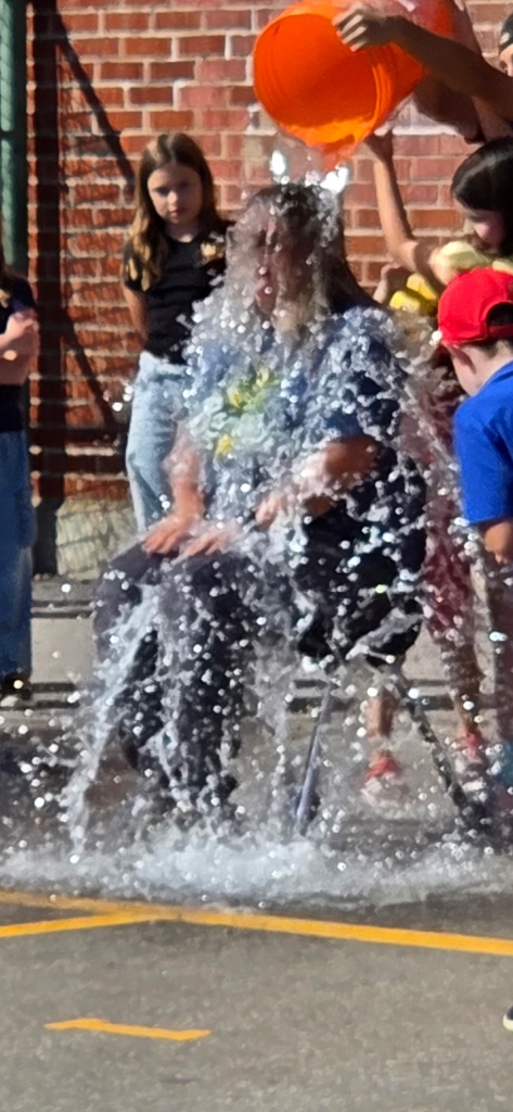 bucket of water being dumped on a teacher by students 