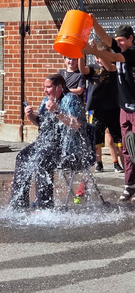 bucket of water being dumped on a teacher by students 