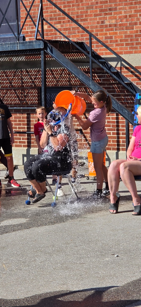 bucket of water being dumped on a teacher by students 