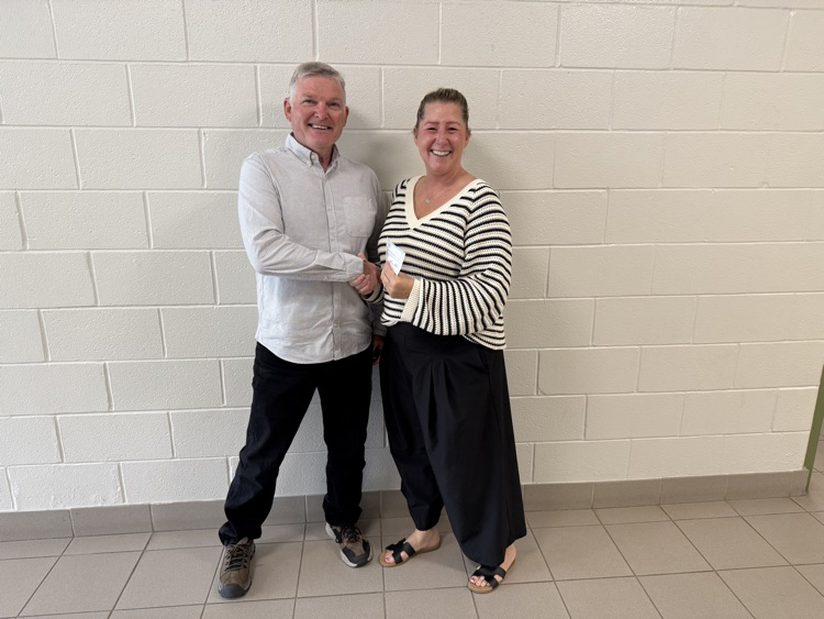 Barry White from the Tilbury Rotary Club presents Jennifer Dresser with a very generous donation to the breakfast and snack program
