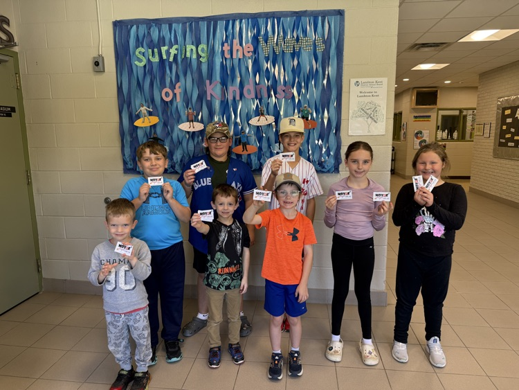 8 students standing with movie tickets