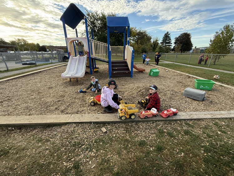 A group of students playing in the mulch