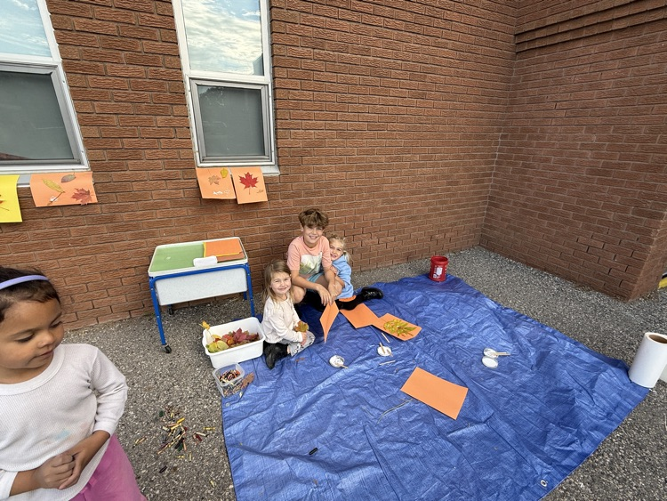 A group of students creating leaf art
