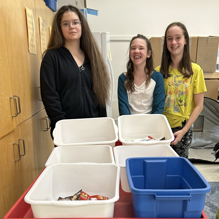 Snack program helpers delivering bins for snack program.