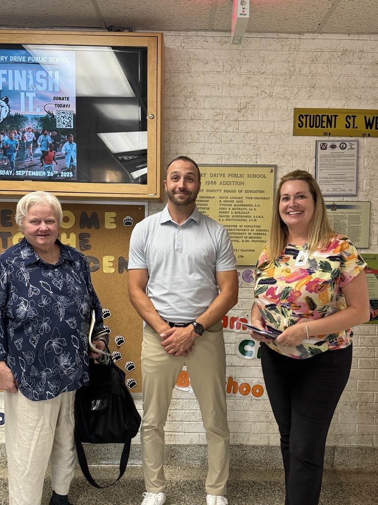 Two trustees pose with principal