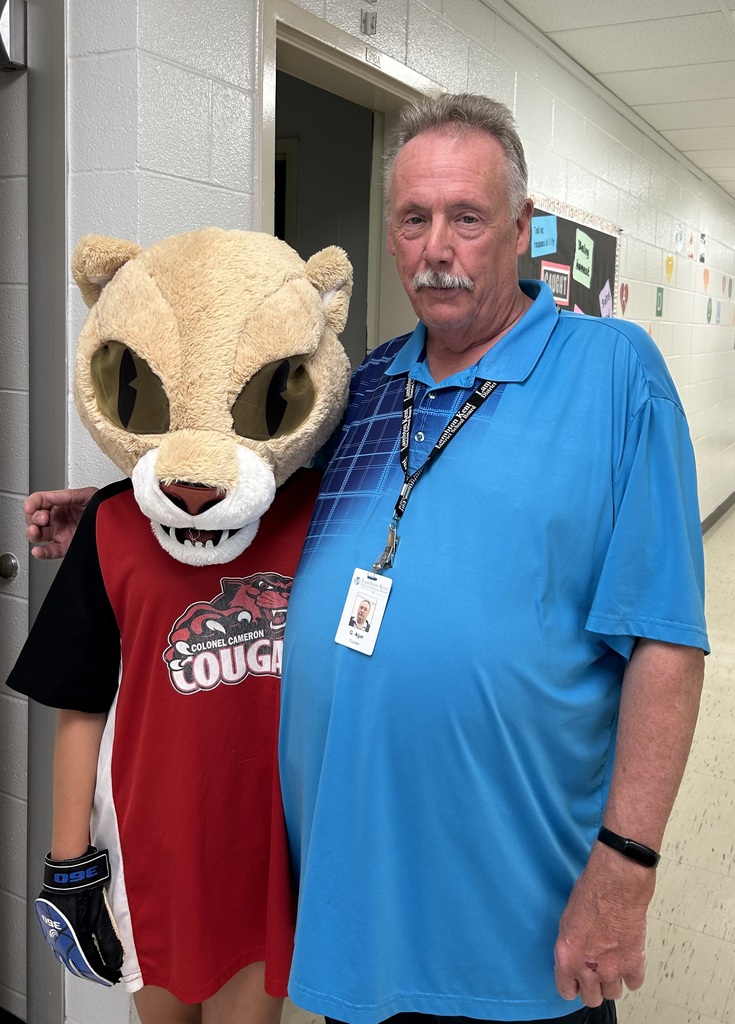 Trustee poses with mascot