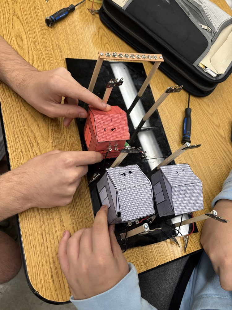 Student placing houses in electrical grid