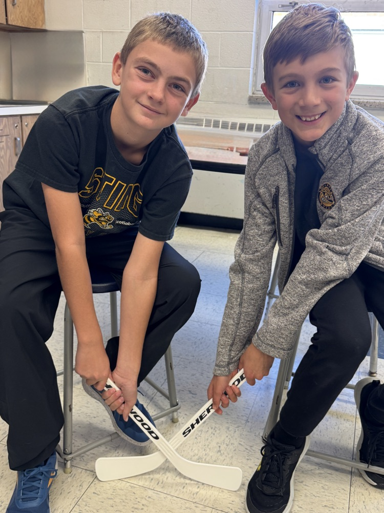 two students twinning as hockey players 