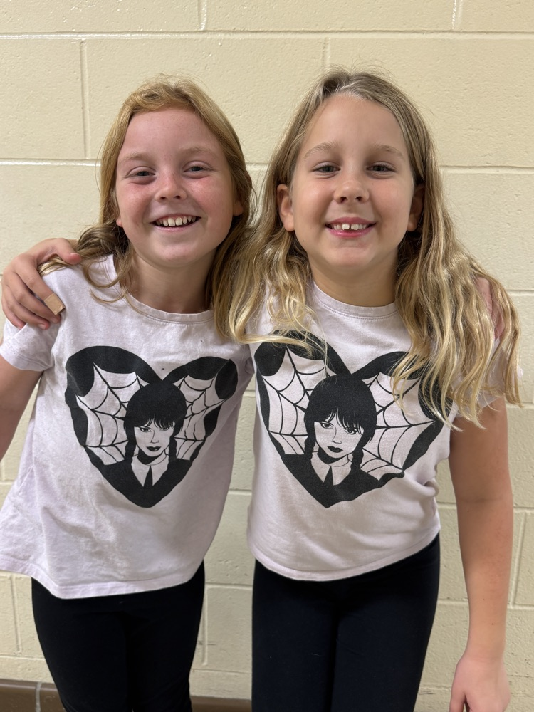 two students wearing the same shirt 