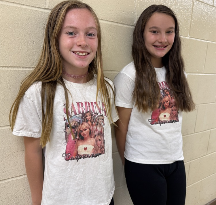 two students wearing the same shirt 