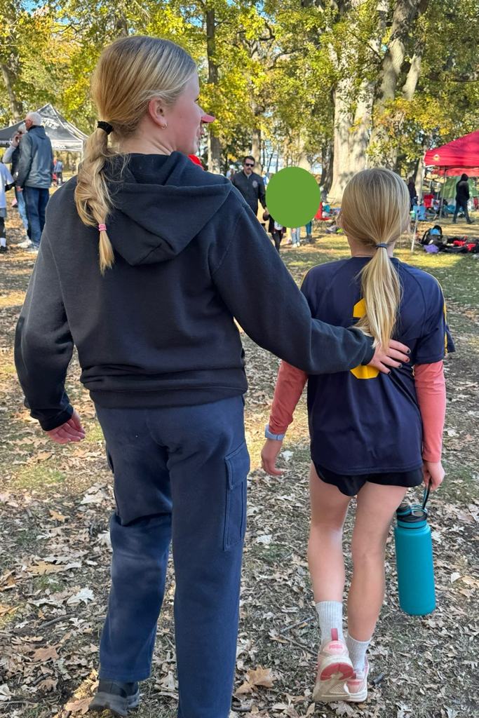 two people standing not facing the camera 