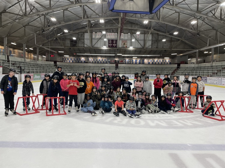 Group of students standing on an ice rink