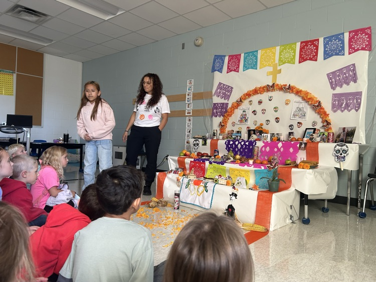Grade 5 student Brittany and Mrs Aguas educate the sk/1 class on Day of the Dead