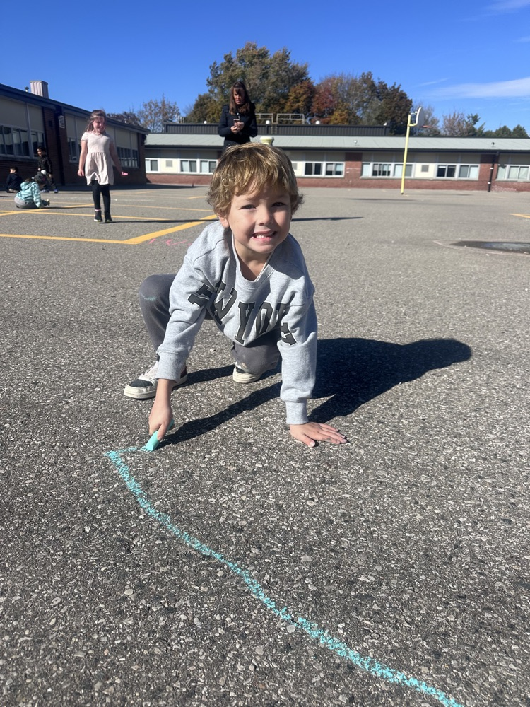 student drying with chalk on blacktop