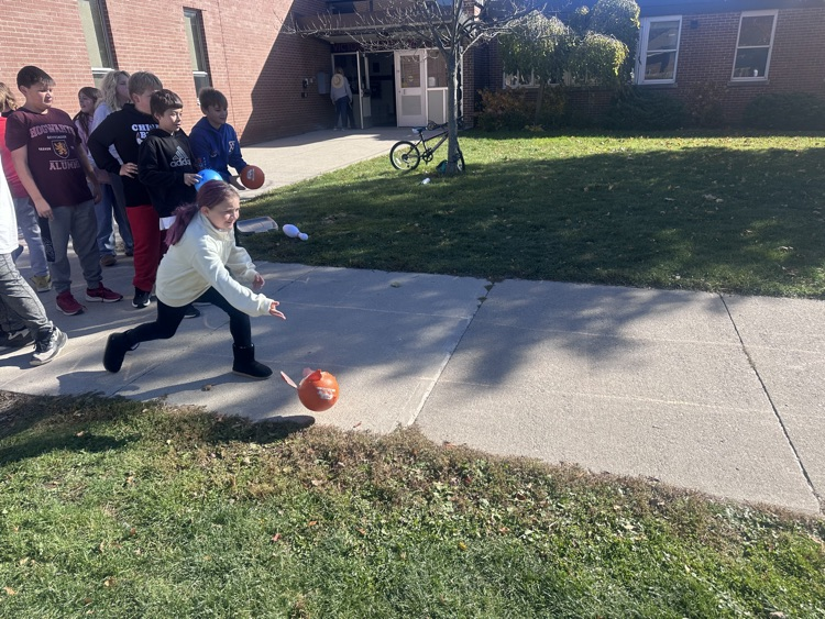 students bowling with pumpkins