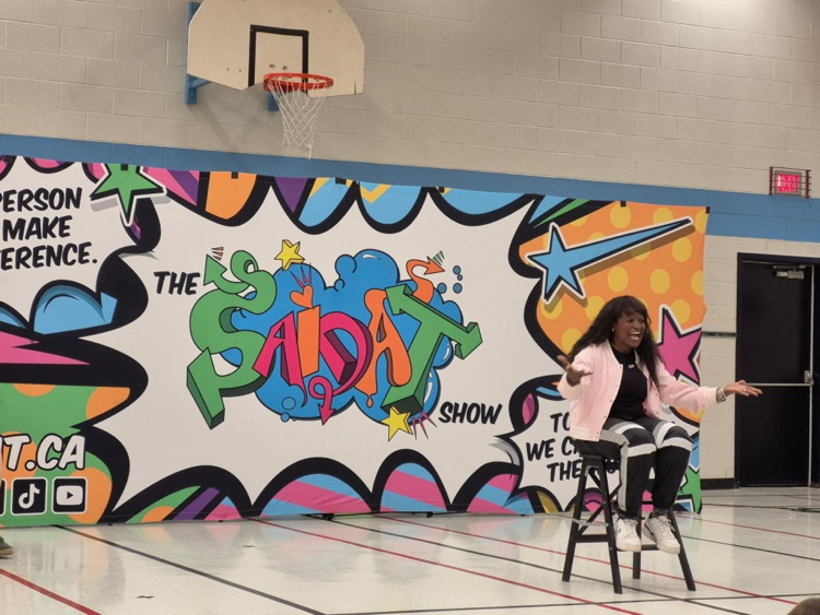 Saidat sitting on a stool delivering a message