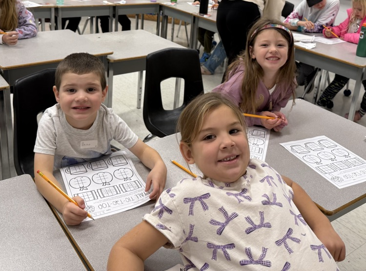 Three students smiling at the camera