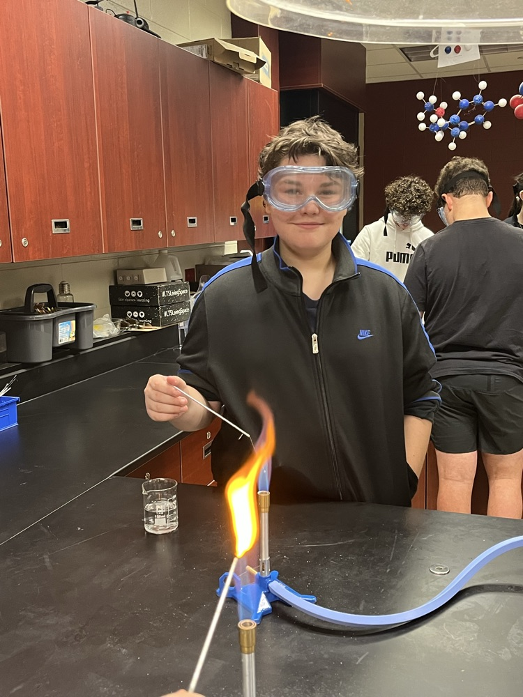 Student working with a Bunsen burner burn