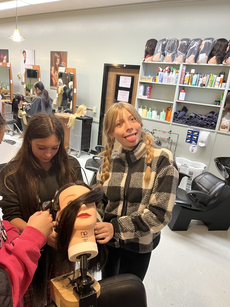 students practising hairdressing in a