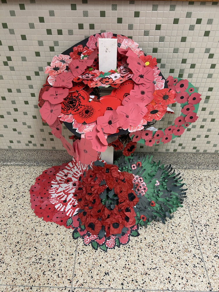 class wreaths laid on cross