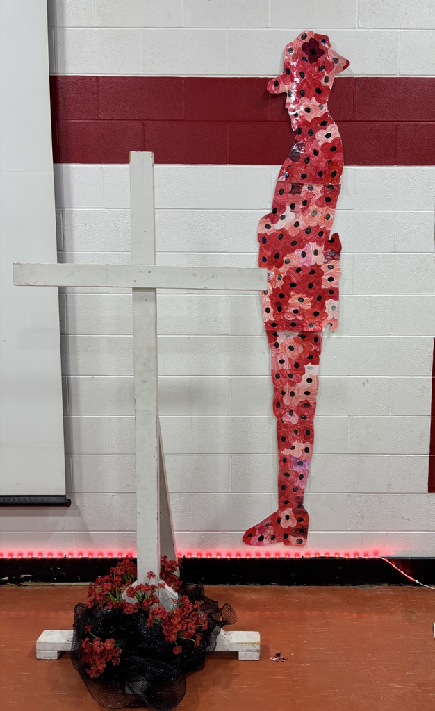 Artwork showing a soldier made out of poppies in front of a cross