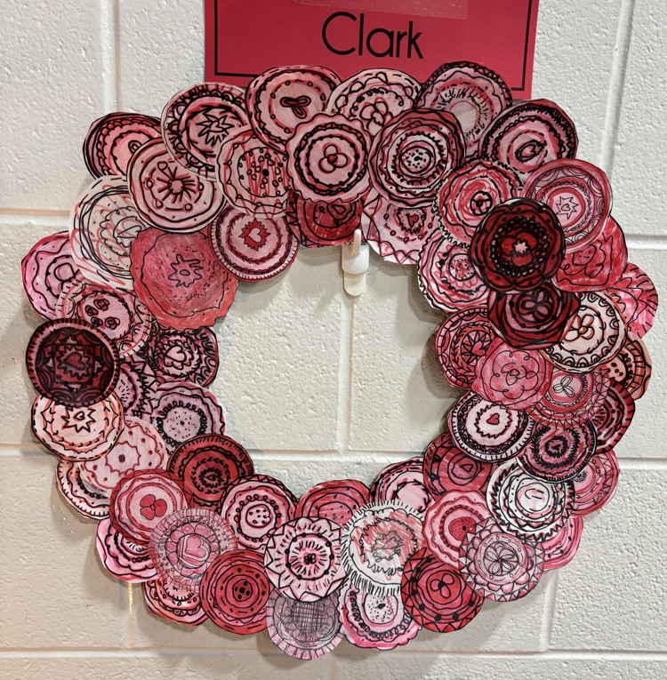 Artwork of a wreath made up of smaller wreaths that resemble poppies
