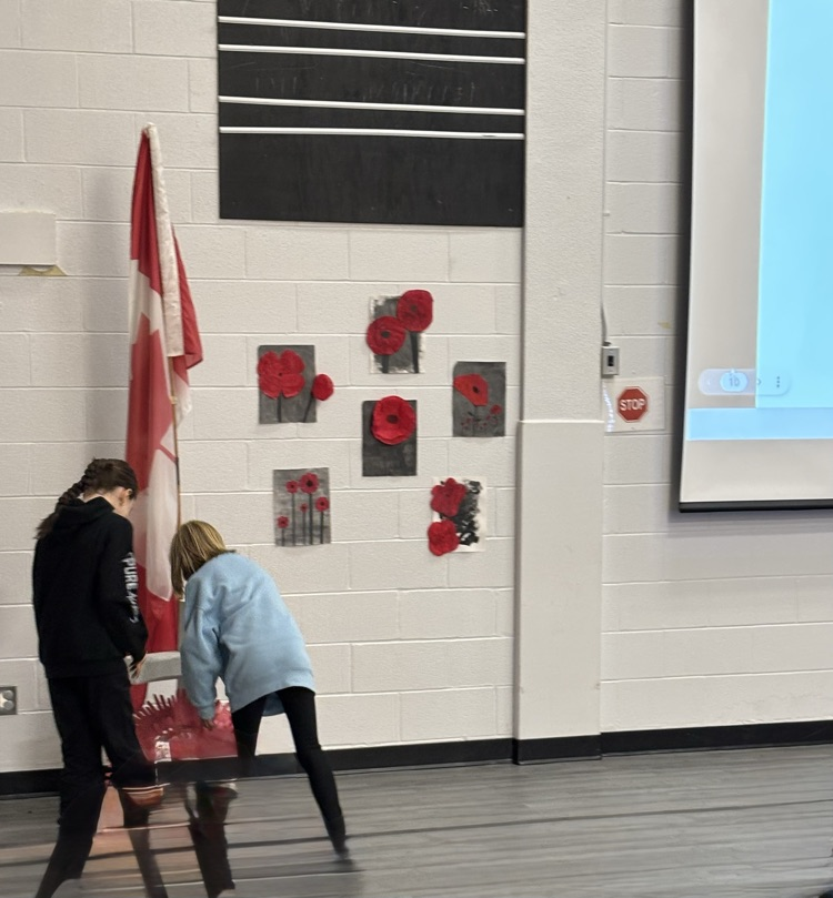 female student from Grade 3 laying a wreath on the cross