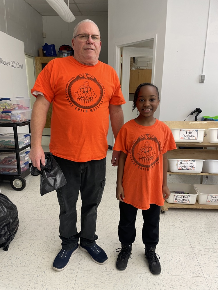 two people wearing orange shirts 