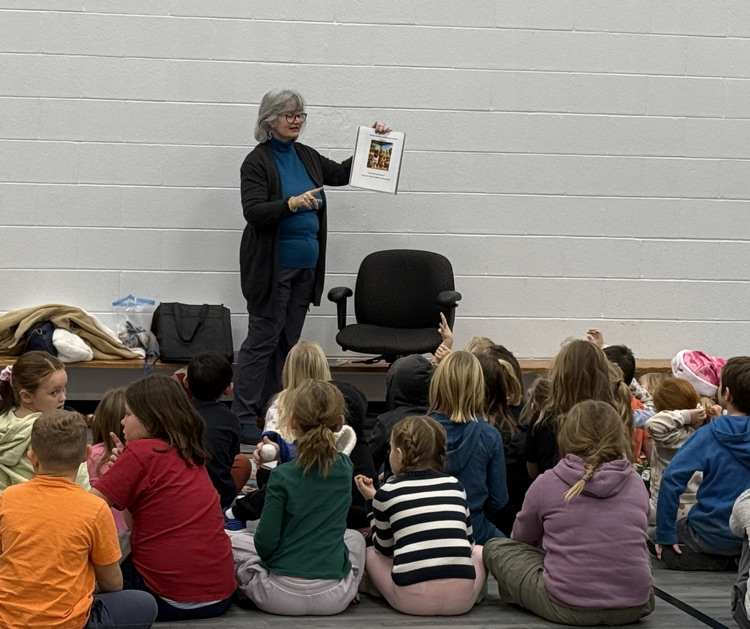Author Jen presenting to a gym full of students