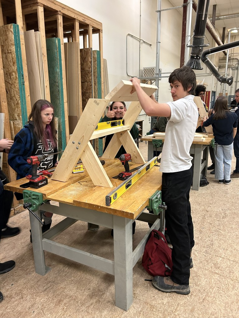 Students constructing a bench.